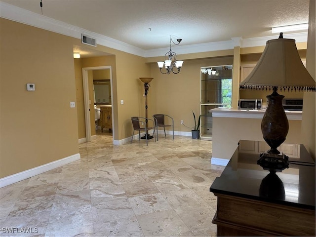 11510 Villa Grand Unit 407, Fort Myers, FL 33913 - kitchen featuring crown molding, a chandelier, stainless steel microwave, pendant lighting, and a textured ceiling