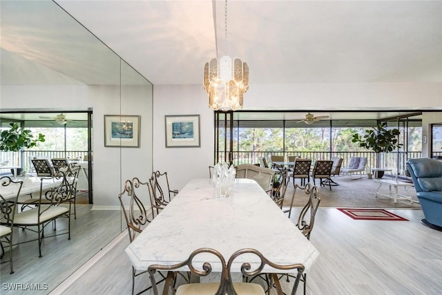 76 Cypress View Dr Unit E-76, Naples, FL 34113 - dining space featuring wood finished floors, a chandelier, baseboards, and a ceiling fan