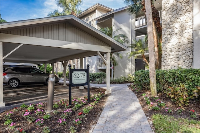 view of vehicle parking with a carport