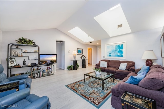 living room with lofted ceiling with skylight and light hardwood / wood-style floors