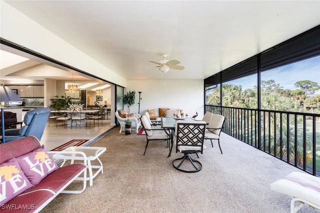 sunroom with ceiling fan with notable chandelier