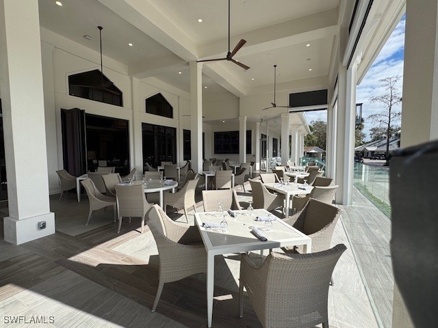 76 Cypress View Dr Unit E-76, Naples, FL 34113 - wooden deck with outdoor dining area, an outdoor hangout area, and a ceiling fan