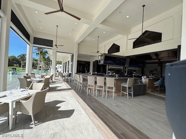 76 Cypress View Dr Unit E-76, Naples, FL 34113 - sunroom / solarium featuring beam ceiling