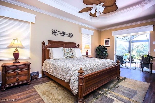 bedroom featuring a raised ceiling, ceiling fan, dark hardwood / wood-style flooring, and ornamental molding