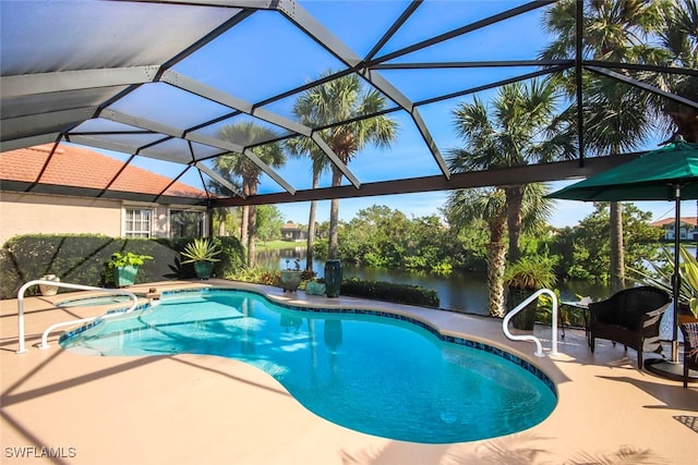 view of pool with a patio, a water view, and glass enclosure