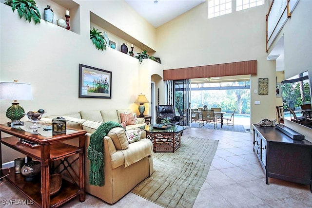 tiled living room featuring a high ceiling