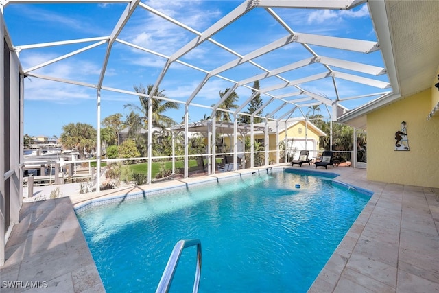 view of pool with glass enclosure and a patio area