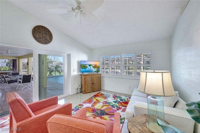 interior space featuring ceiling fan, lofted ceiling, and light tile patterned floors