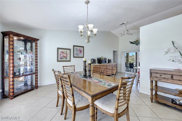 tiled dining space featuring ceiling fan with notable chandelier and lofted ceiling