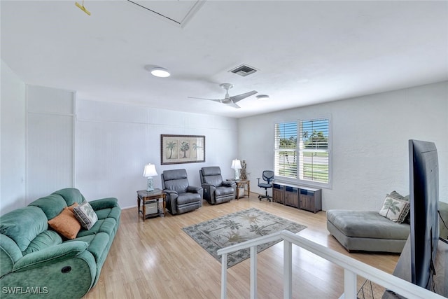 living room with ceiling fan and wood-type flooring