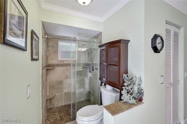 bathroom with crown molding, an enclosed shower, and toilet