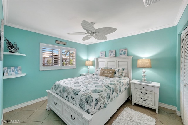 bedroom featuring ceiling fan, a closet, light tile patterned flooring, and crown molding