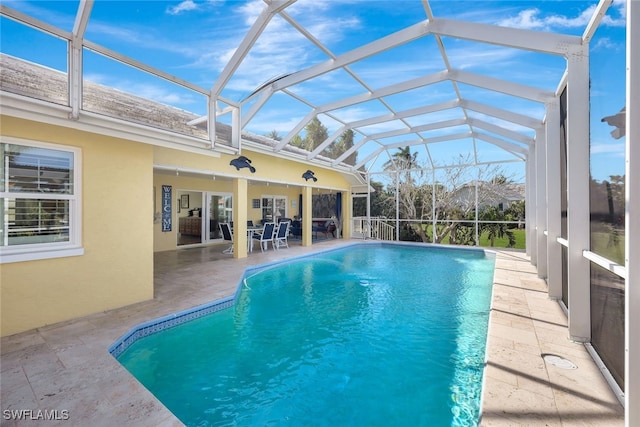 view of pool with a patio and a lanai