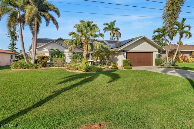 single story home with a front yard, solar panels, and a garage