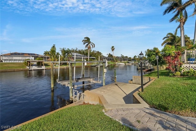 view of dock featuring a lawn and a water view