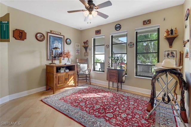 sitting room with ceiling fan, light hardwood / wood-style flooring, and a healthy amount of sunlight