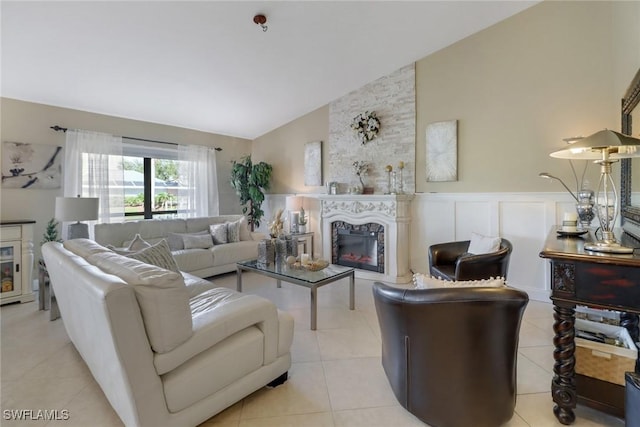 tiled living room featuring a fireplace and high vaulted ceiling