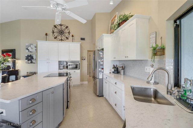 kitchen featuring appliances with stainless steel finishes, gray cabinets, white cabinetry, and sink