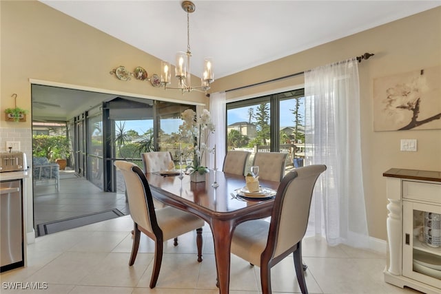 tiled dining space featuring a chandelier and lofted ceiling