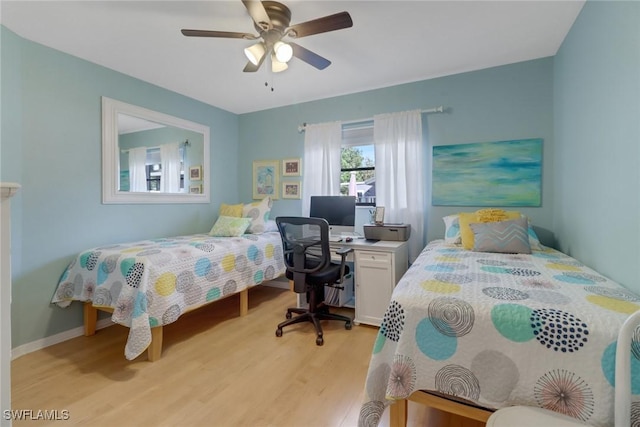 bedroom with light hardwood / wood-style floors and ceiling fan