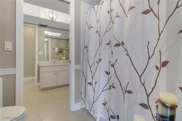 bathroom featuring a shower with curtain, tile patterned flooring, vanity, and toilet