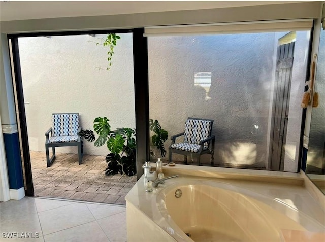 bathroom featuring tile patterned floors and a tub to relax in