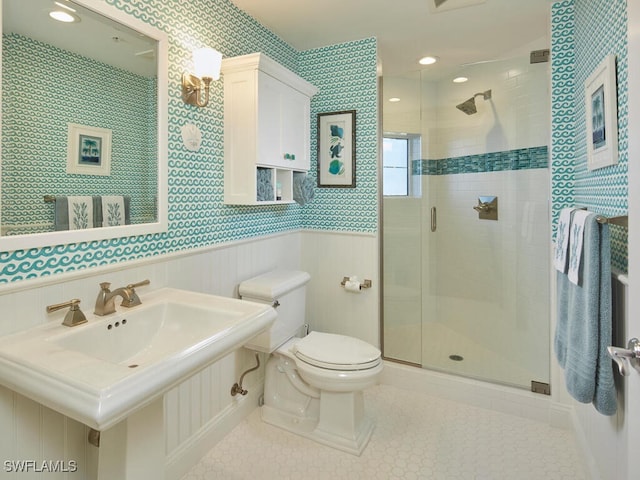 bathroom featuring an enclosed shower, toilet, and sink