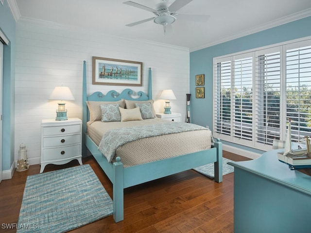 bedroom featuring dark hardwood / wood-style flooring, ceiling fan, and ornamental molding