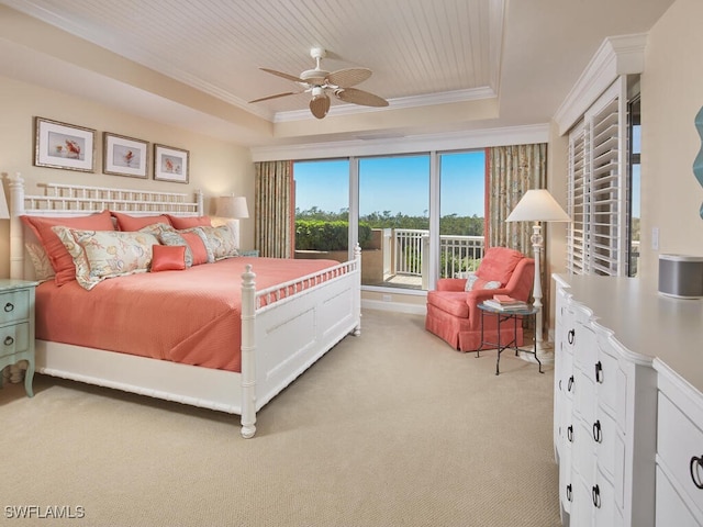 bedroom featuring a tray ceiling, ceiling fan, crown molding, and light carpet