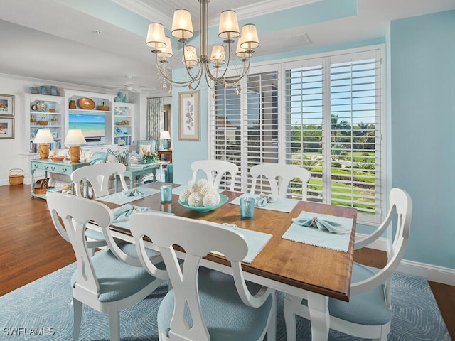 dining space featuring a chandelier, crown molding, and dark wood-type flooring