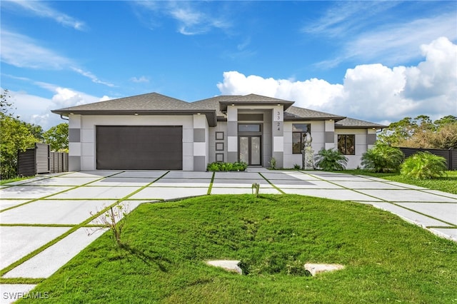 prairie-style house with a front lawn and a garage