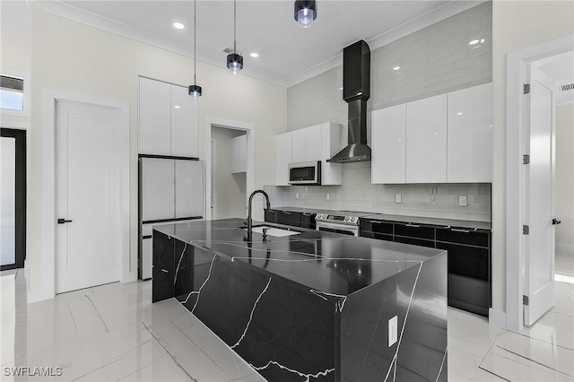 kitchen with stainless steel appliances, a kitchen island with sink, sink, white cabinets, and hanging light fixtures