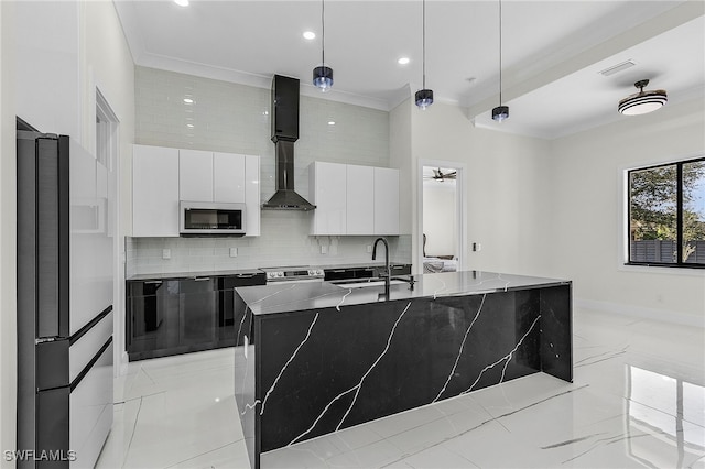 kitchen featuring hanging light fixtures, white cabinetry, a kitchen island with sink, and appliances with stainless steel finishes