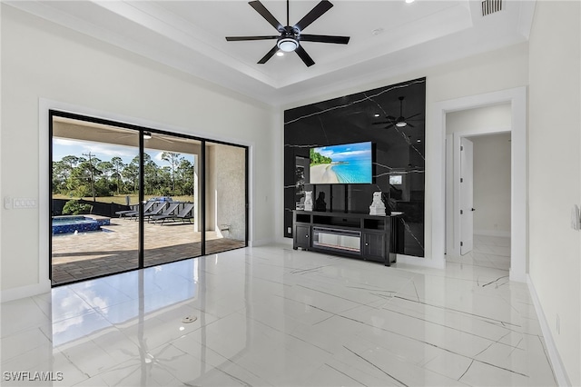 living room featuring ceiling fan and a tray ceiling