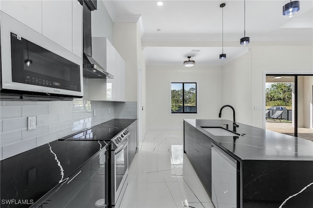 kitchen featuring pendant lighting, white cabinets, sink, decorative backsplash, and stainless steel appliances