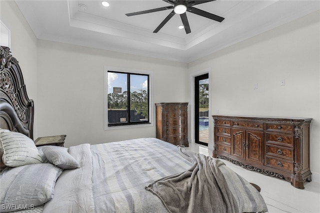 bedroom with access to outside, a raised ceiling, and ceiling fan