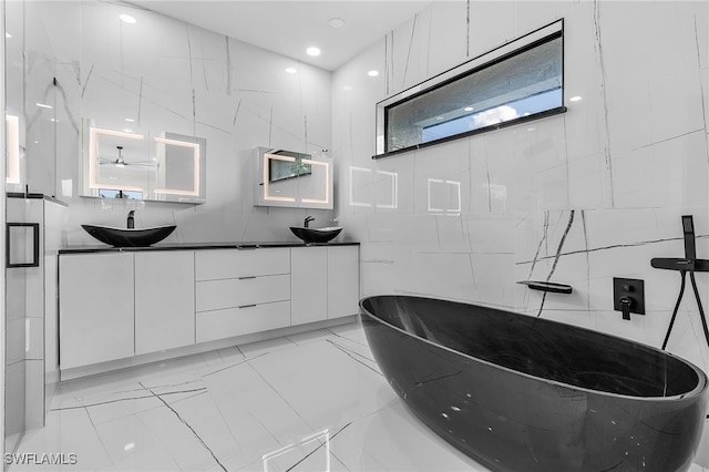 bathroom with a shower, vanity, and tile walls