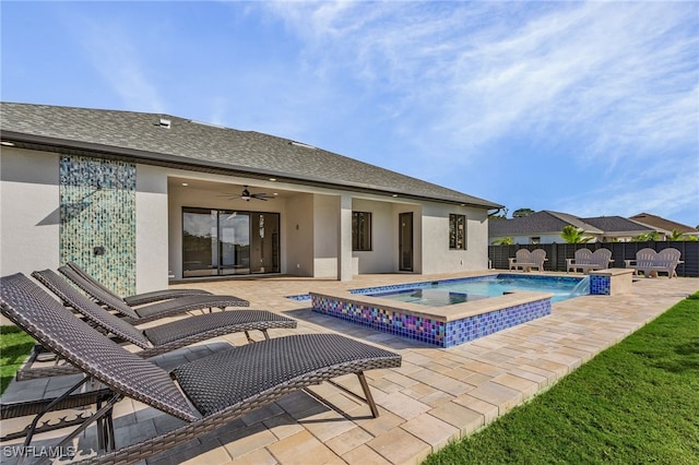 view of swimming pool featuring a patio area, an in ground hot tub, pool water feature, and ceiling fan