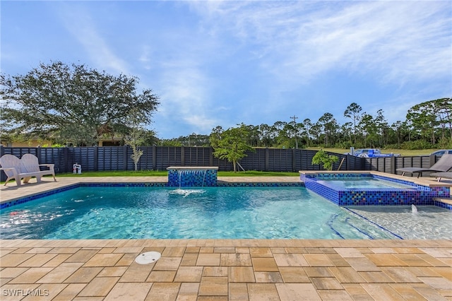 view of pool featuring pool water feature and an in ground hot tub