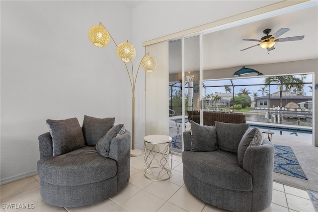 sitting room featuring ceiling fan and light tile patterned flooring