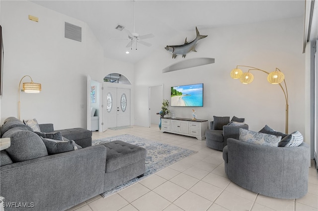 tiled living room featuring ceiling fan and high vaulted ceiling