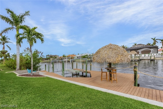 view of dock featuring a water view and a lawn