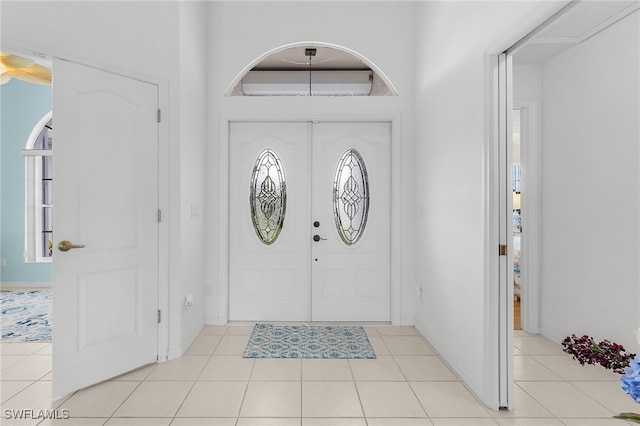 foyer entrance with light tile patterned floors