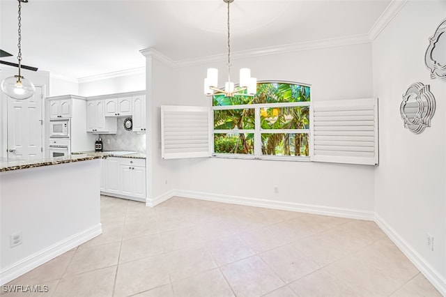 kitchen featuring white cabinets, crown molding, white appliances, and hanging light fixtures