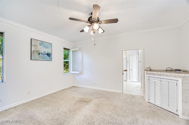 empty room featuring ceiling fan, light colored carpet, and ornamental molding