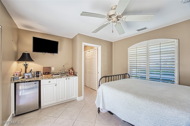 tiled bedroom featuring stainless steel fridge, a closet, ceiling fan, and sink