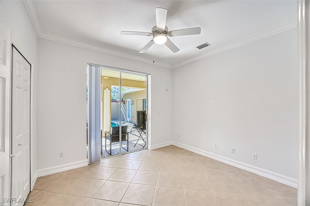 empty room featuring crown molding, ceiling fan, and light tile patterned flooring