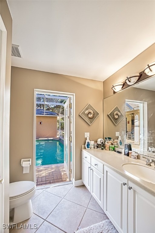 bathroom featuring tile patterned flooring, vanity, and toilet