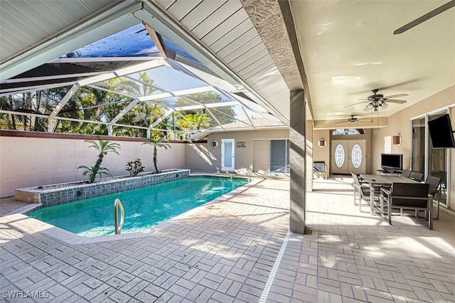 view of swimming pool with a patio, ceiling fan, and a lanai