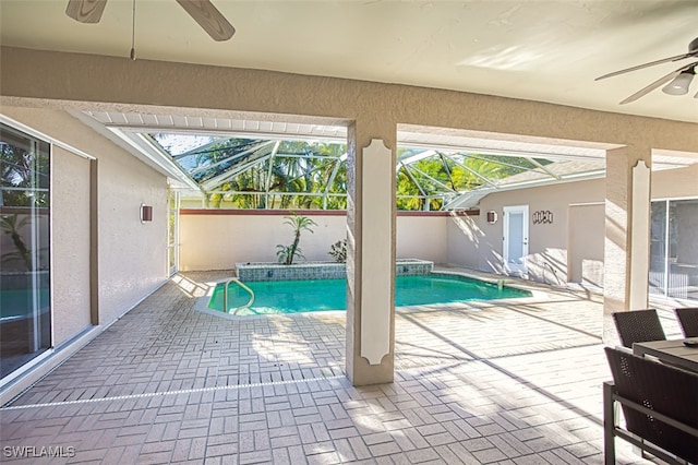 view of pool with a lanai, ceiling fan, and a patio area